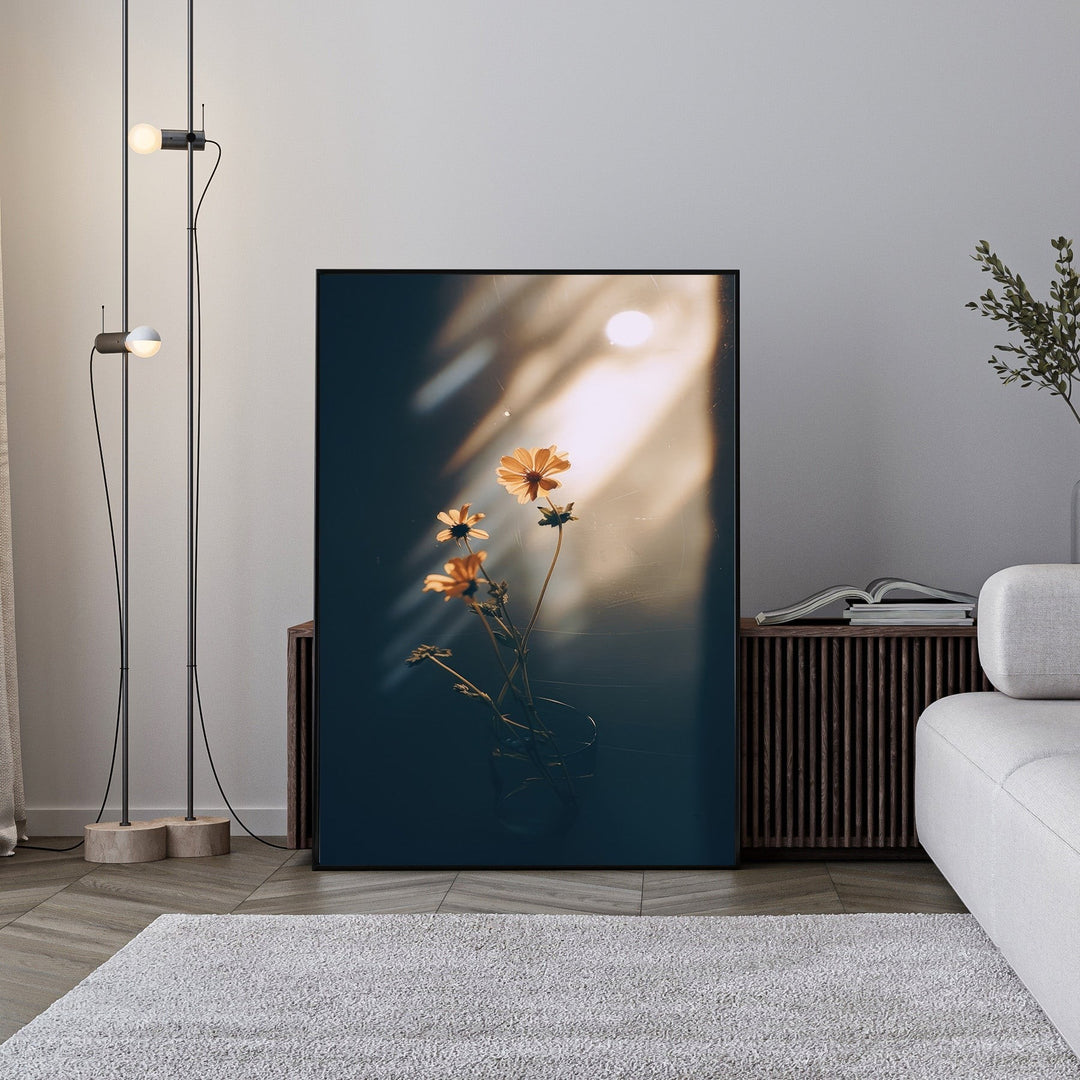 Wadi Home framed print of delicate orange flowers in a glass vase, bathed in warm sunlight with dramatic shadows.