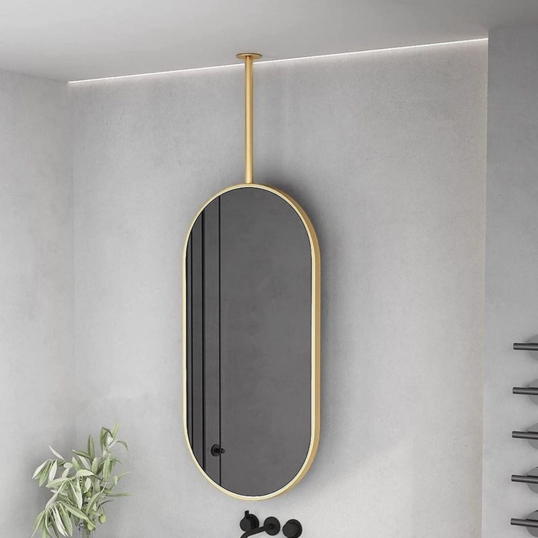 Wadi Home modern oval ceiling-mounted bathroom mirror with a sleek gold frame in a contemporary interior.