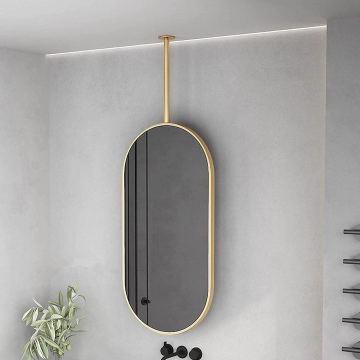 Wadi Home modern oval ceiling-mounted bathroom mirror with a sleek gold frame in a contemporary interior.