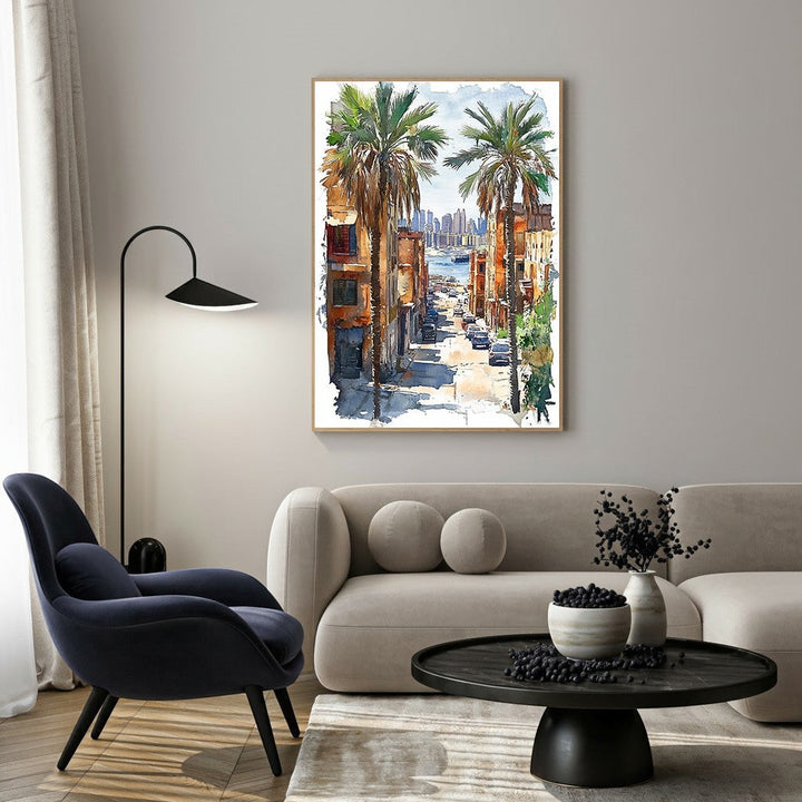 Wadi Home watercolor art of a palm tree lined city street leading to a bay with buildings. Vibrant colors.