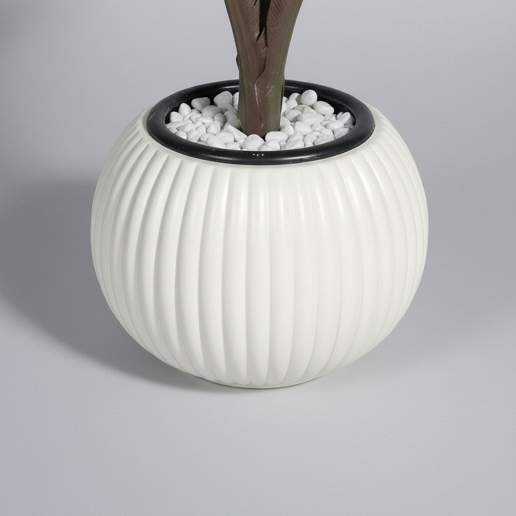 Wadi Home artificial fan palm plant in a modern white ribbed ceramic-style pot with decorative white pebbles