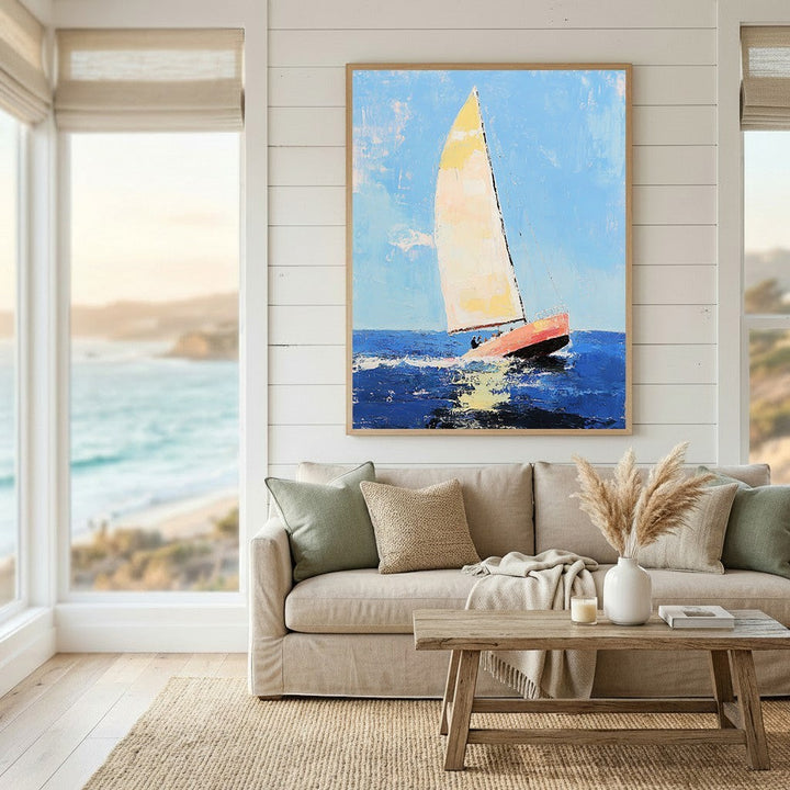 Wadi Home sailboat nautical canvas print with textured blue ocean and yellow sail hanging above a neutral sofa