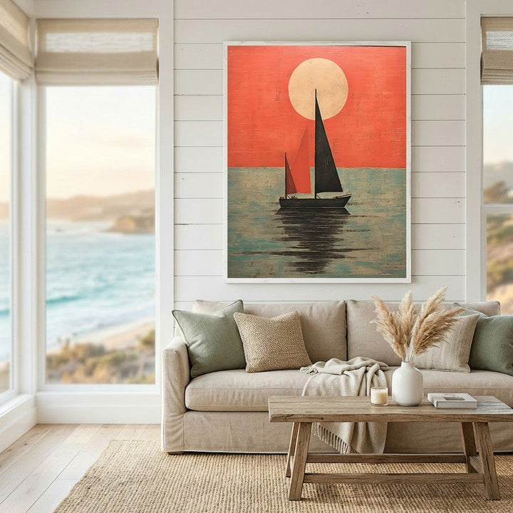 Wadi Home framed sailboat at sunset wall art print with red and teal tones hanging above a neutral living room sofa.