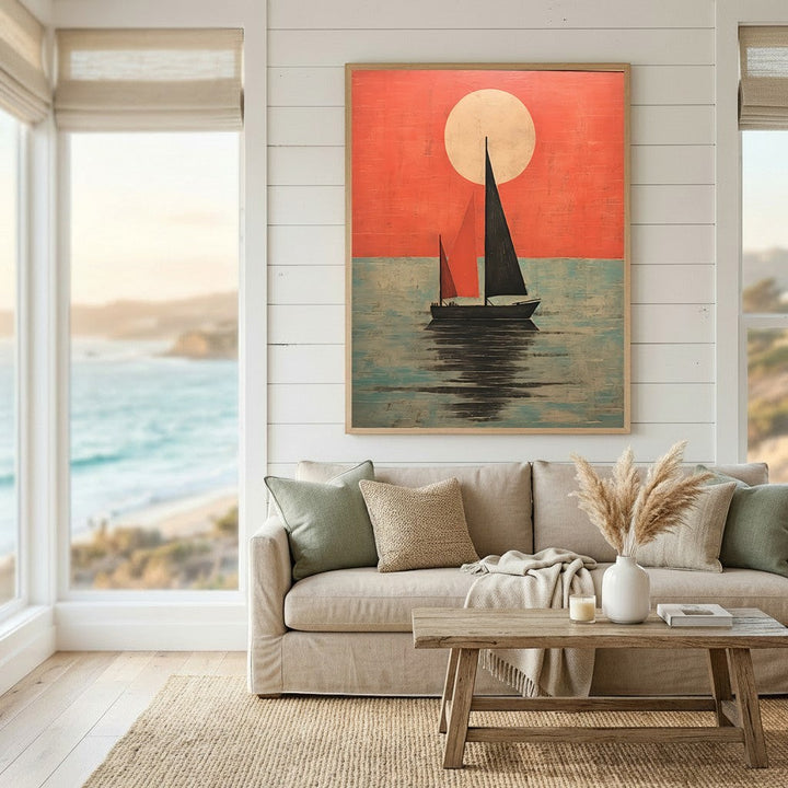 Wadi Home framed sailboat at sunset wall art print with red and teal tones hanging above a neutral living room sofa.