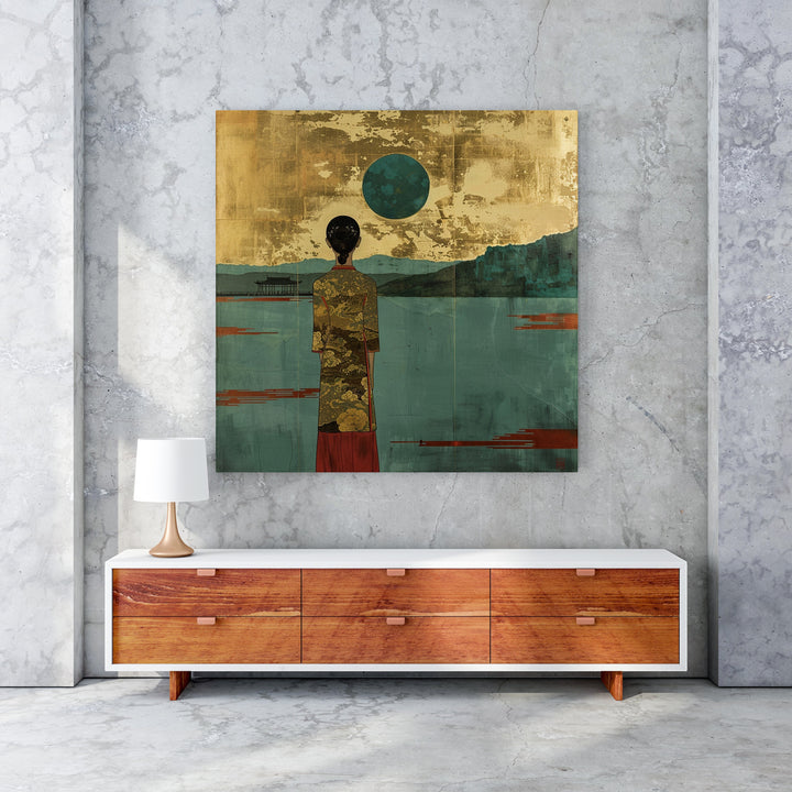 Wadi Home serene landscape wall art with figure in gold patterned robe, teal water, and gold textured sky.