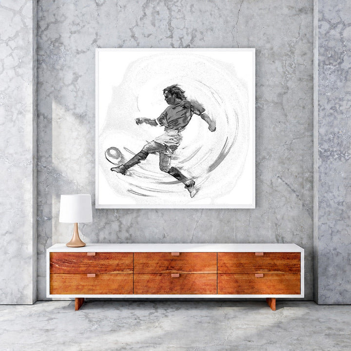 Wadi Home black and white sketch artwork of a soccer player in mid-kick action, framed in white.