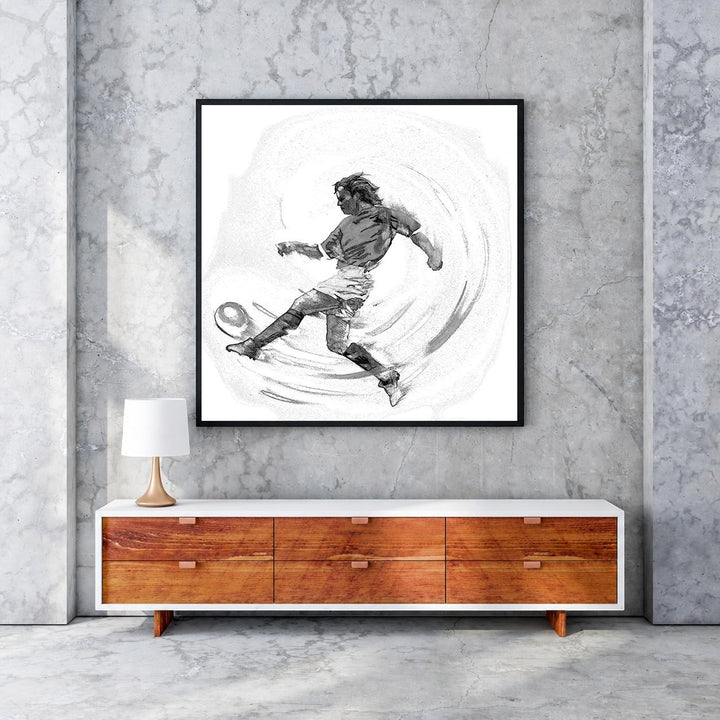 Wadi Home black and white sketch artwork of a soccer player mid-kick, framed in black.