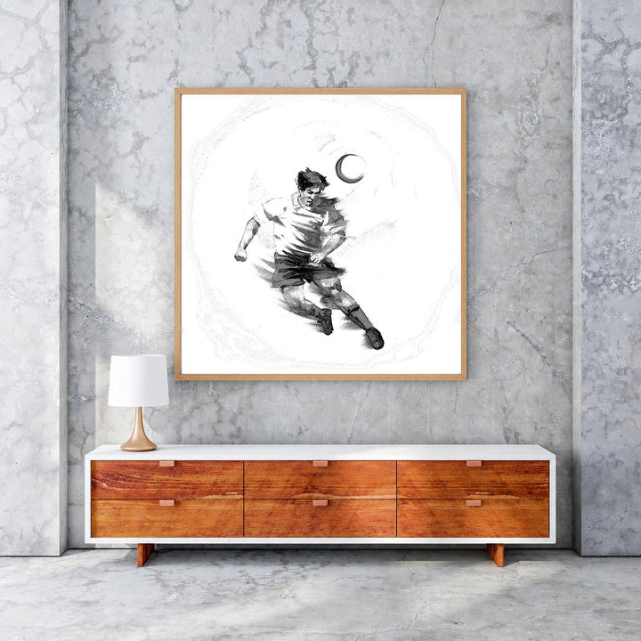 Wadi Home black and white sketch artwork of a soccer player dribbling a ball under a crescent moon.