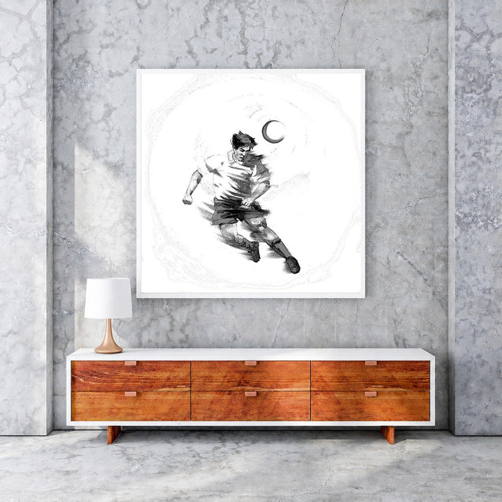 Wadi Home black and white sketch artwork of a soccer player dribbling a ball under a crescent moon.
