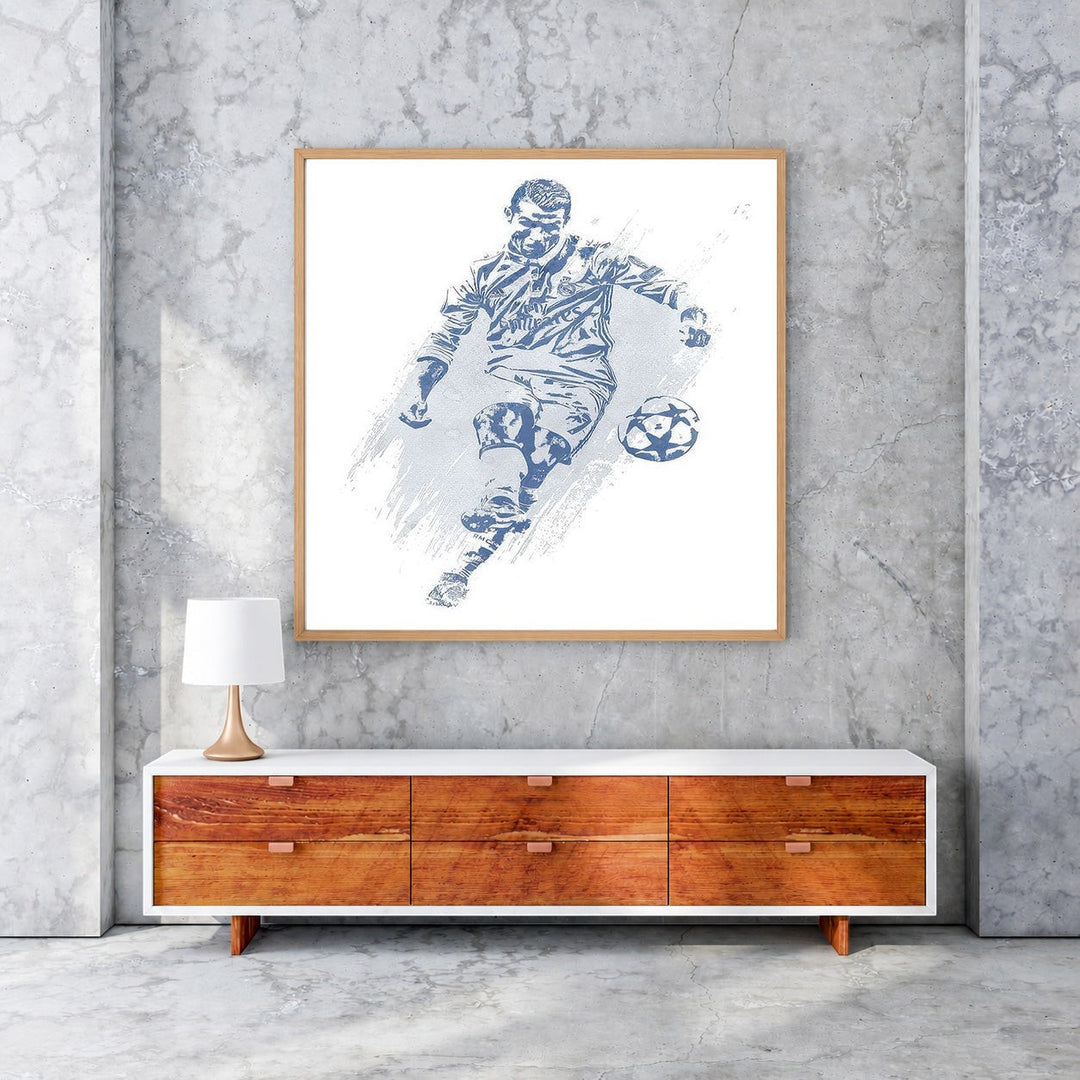 Wadi Home framed blue and white soccer player action shot wall art, stylized depiction of a player kicking a ball.