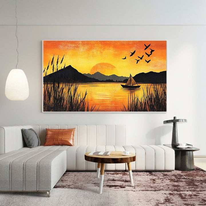 Wadi Home sunset lake landscape wall art print featuring a golden horizon, sailboat, and birds above a modern sofa.