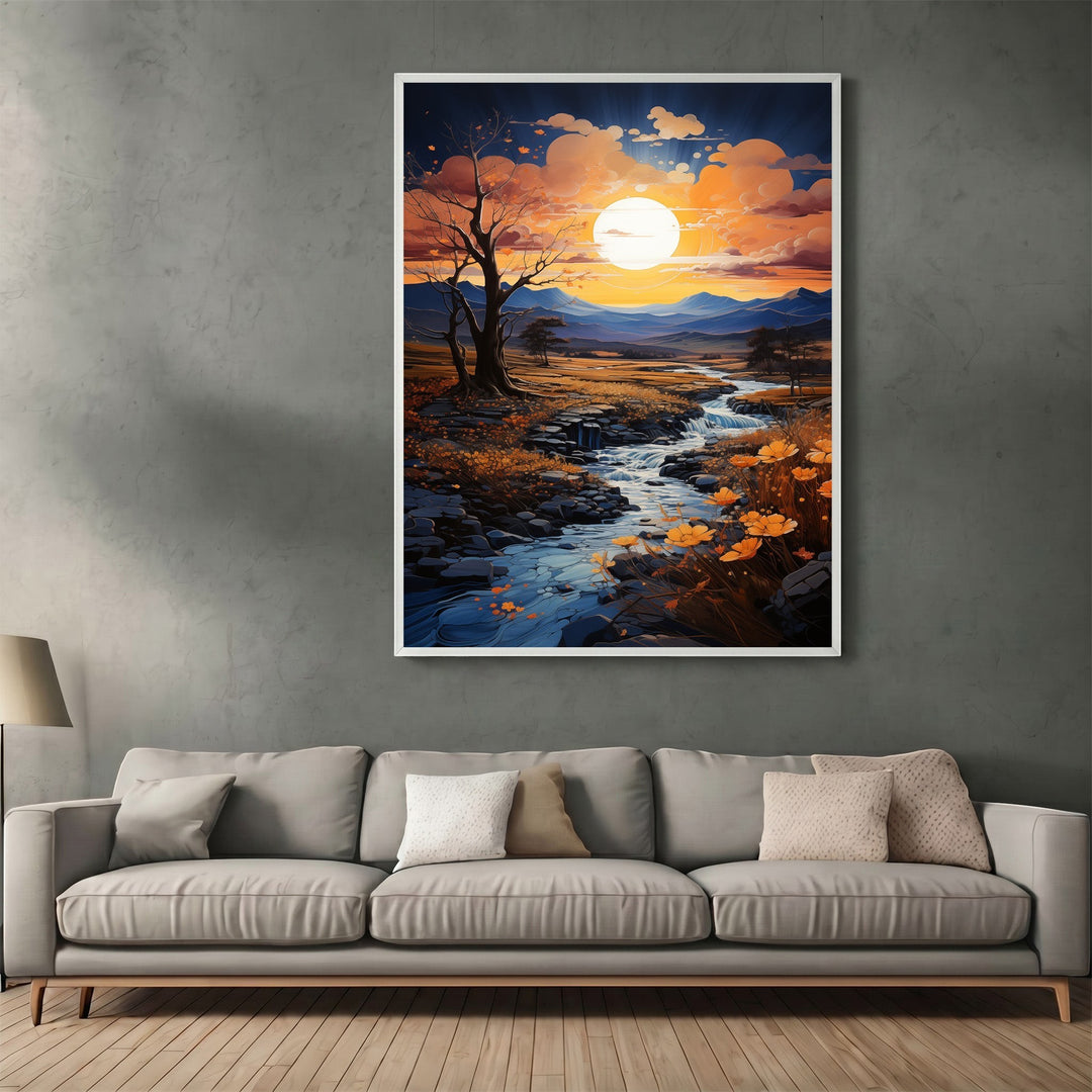 Wadi Home framed sunset landscape wall art print featuring a winding stream and golden hills above a modern grey sofa.