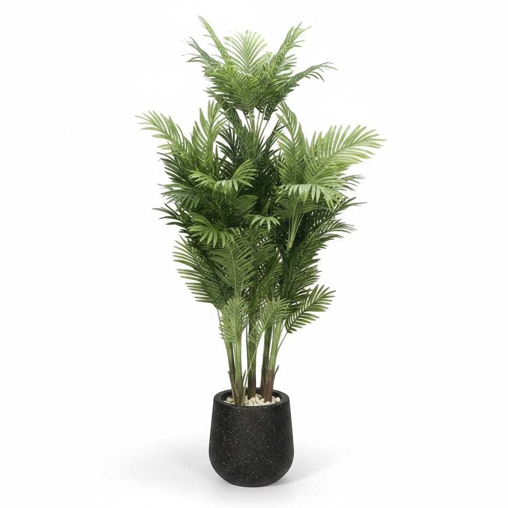 Wadi Home tall faux Areca palm tree with lush green fronds in a black speckled planter with white stones.