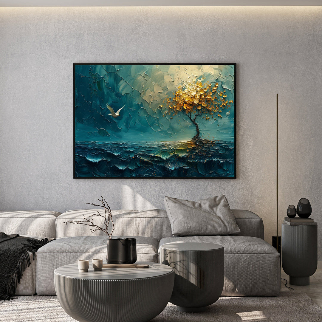 Wadi Home textured landscape wall art featuring a moody teal seascape and golden tree hanging above a grey sofa.