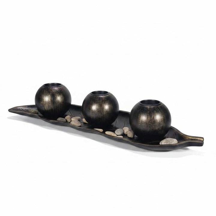 Wadi Home dark metal three sphere candle holder set on leaf tray with stones