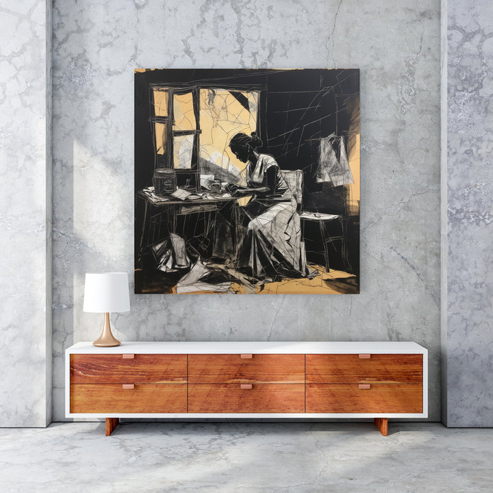 Wadi Home black and white sketch wall art of a woman working at a table with golden accents.