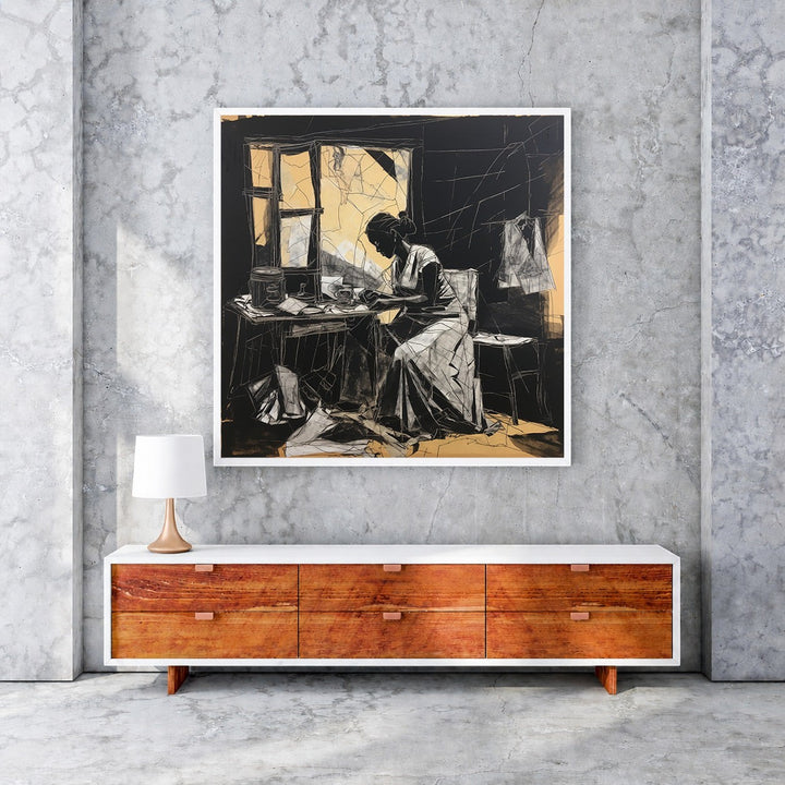 Wadi Home framed black and white sketch art of a woman working at a table with golden accents.