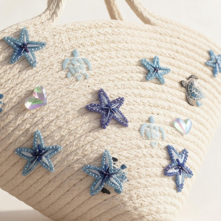 Wadi Home off-white woven beach tote bag featuring blue beaded starfish and sea turtle embellishments