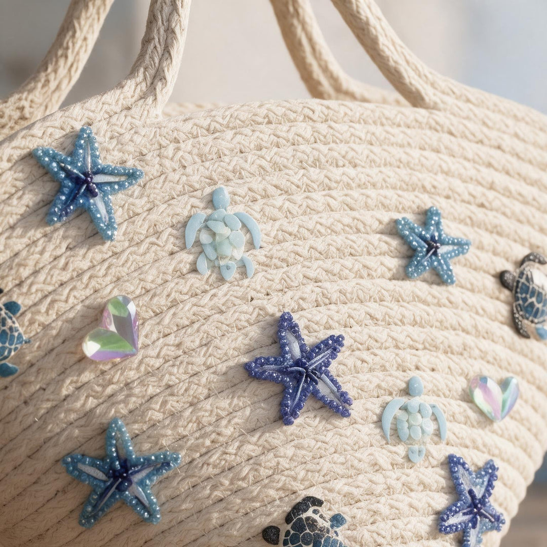 Wadi Home off-white woven rope beach tote bag featuring blue beaded starfish, sea turtle, and heart embellishments.