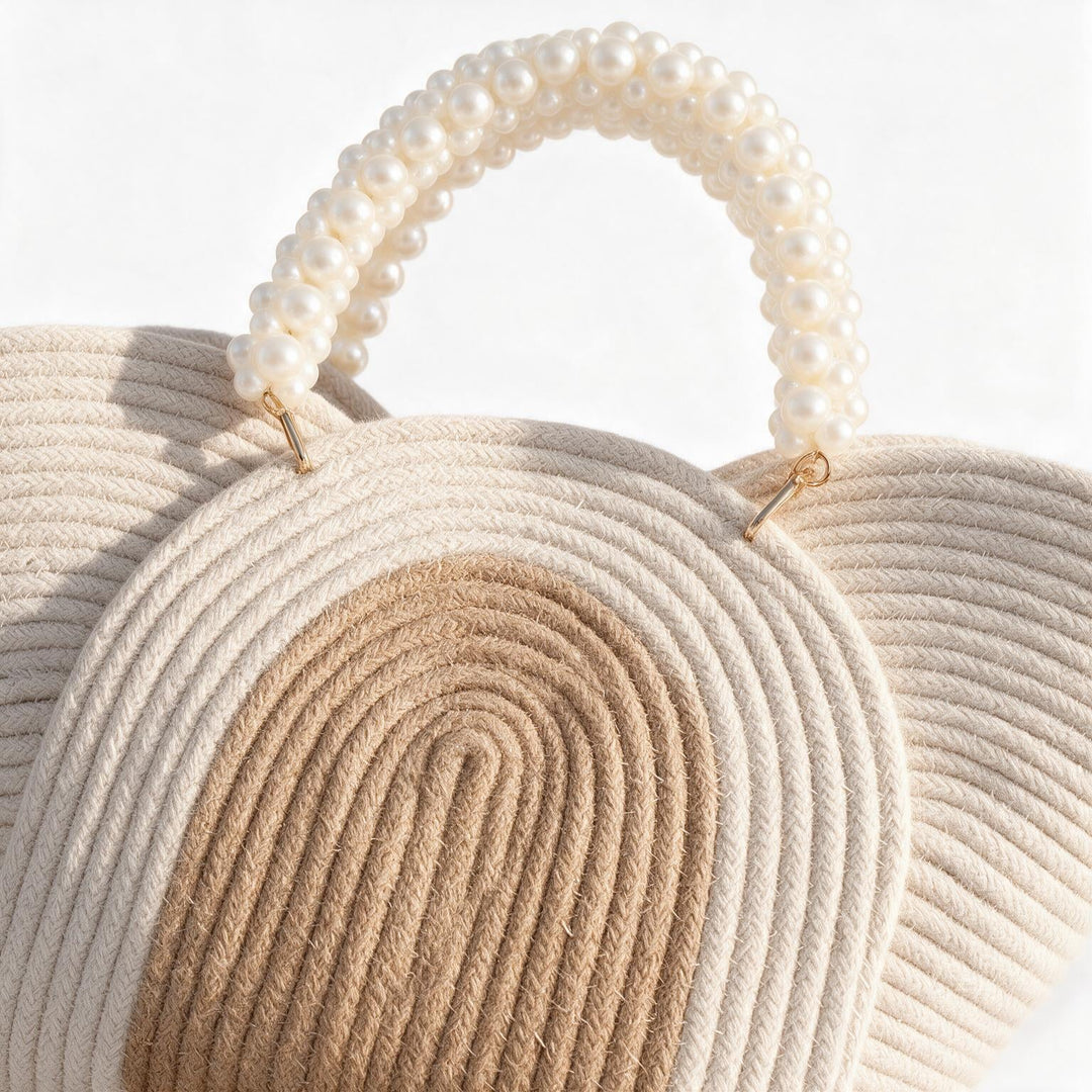 Wadi Home beige braided rope handbag featuring a chic pearl-beaded handle and two-tone natural woven design