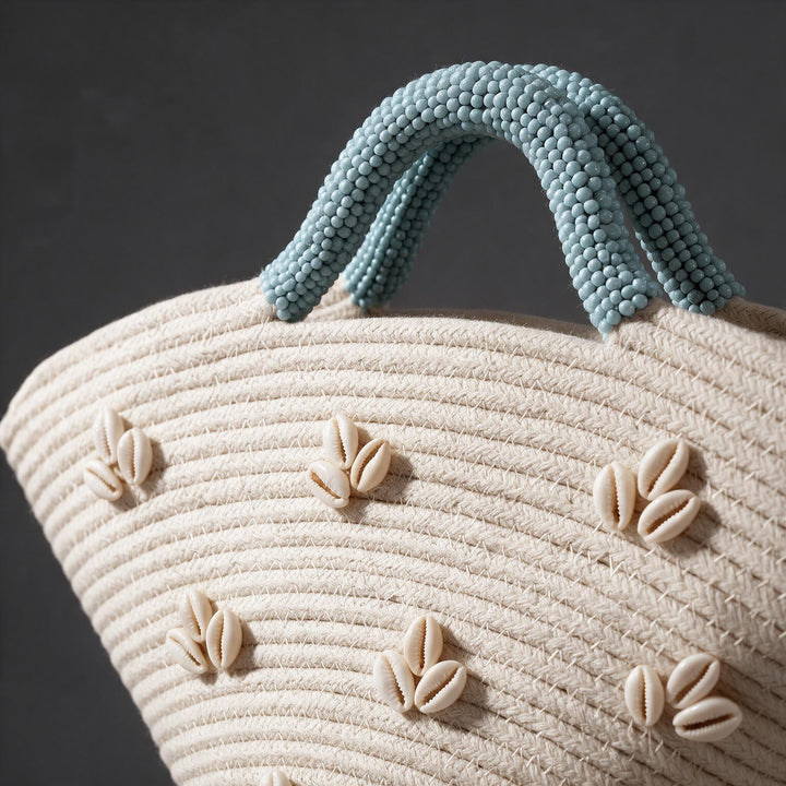 Wadi Home beige woven beach handbag with shell embellishments and textured light blue beaded handles