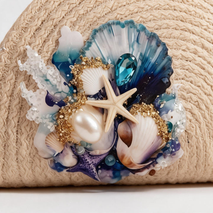 Wadi Home beige woven straw beach clutch featuring a seashell, starfish, pearl, and blue crystal ocean-themed design.