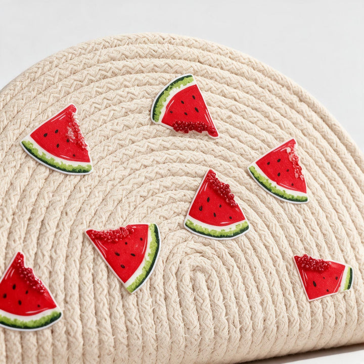 Wadi Home beige woven half moon clutch with playful watermelon slice embellishments for a summer beach look.
