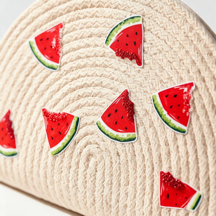 Wadi Home beige woven half moon clutch with playful red watermelon slice prints for a summer beach look