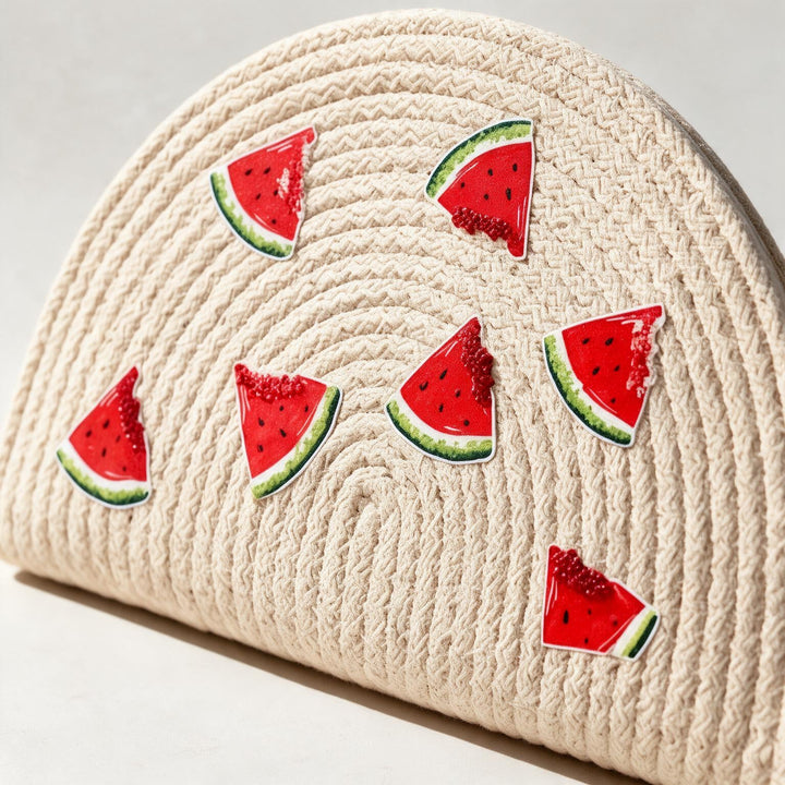 Wadi Home beige woven half moon clutch handbag featuring playful watermelon slice prints for a summer look.