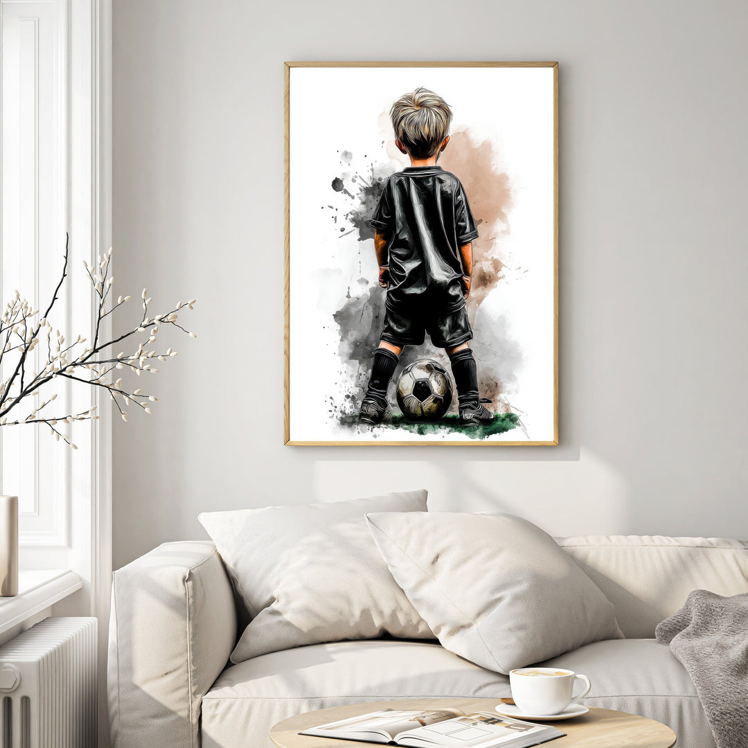 Wadi Home artwork of a young boy in a black soccer uniform with a ball at his feet, watercolor style.
