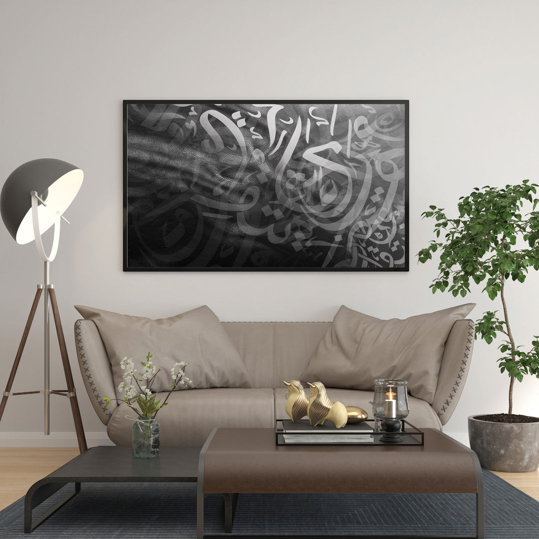 Wadi Home abstract Arabic calligraphy wall art in monochrome palette, framed and displayed above a sofa.