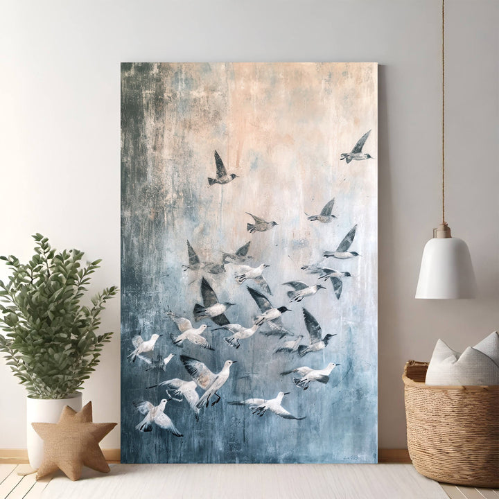 Wadi Home abstract wall art featuring a flock of birds in flight, with a textured background in blues, grays, and peachy tones.