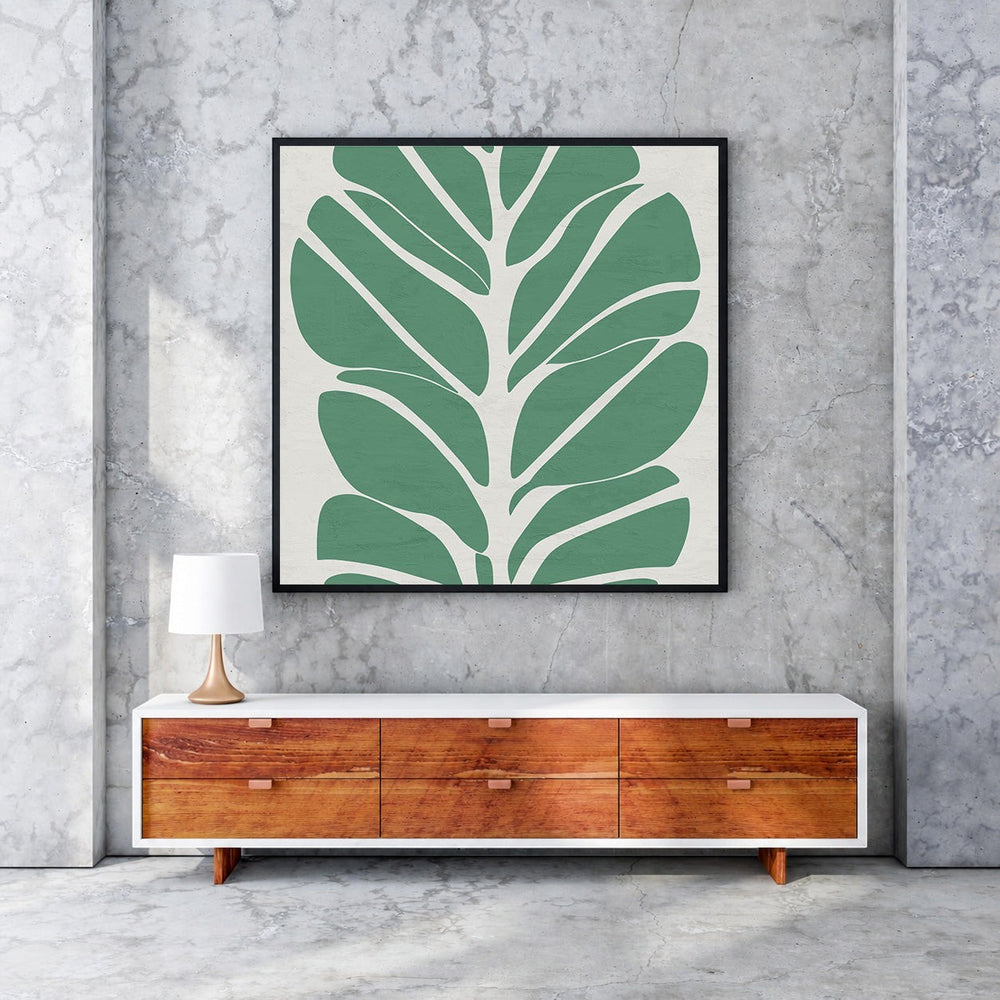 Wadi Home abstract botanical leaf wall art, minimalist green leaves on cream background, framed in black.