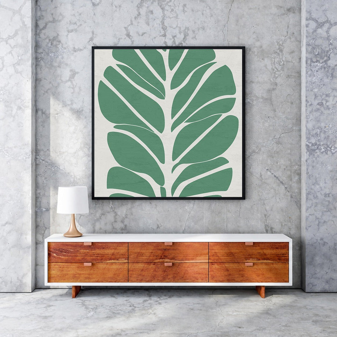Wadi Home abstract botanical leaf wall art, minimalist green leaves on cream background, framed in black.