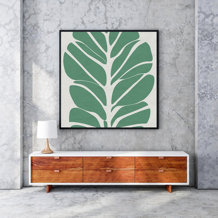Wadi Home abstract botanical leaf wall art, minimalist green leaves on cream background, framed in black.
