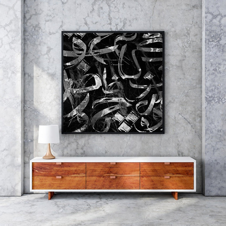 Wadi Home abstract calligraphy wall art with black and silver brushstrokes on a black marble background.