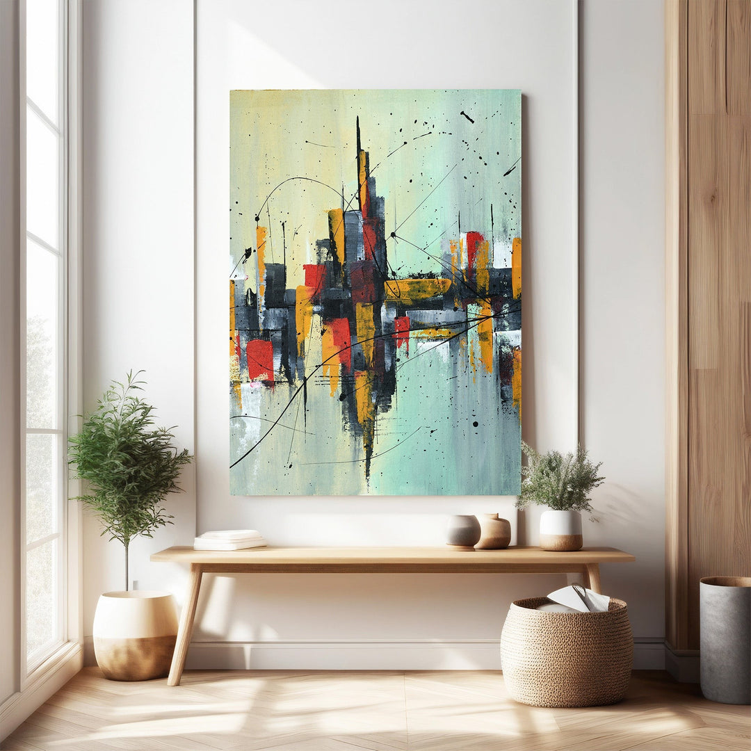 Wadi Home abstract cityscape canvas art with reds, yellows, blacks, and blues. Textured finish, modern design.