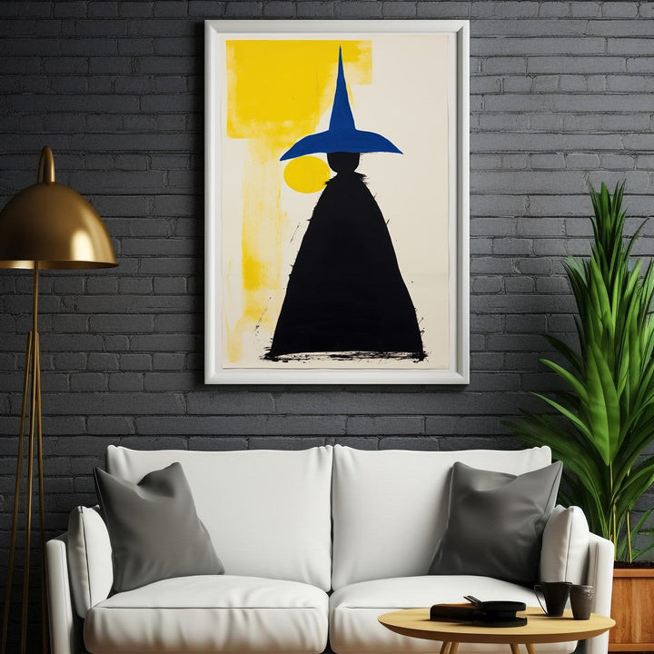 Wadi Home abstract wall art featuring a black figure with a blue pointed hat against a yellow and white background.