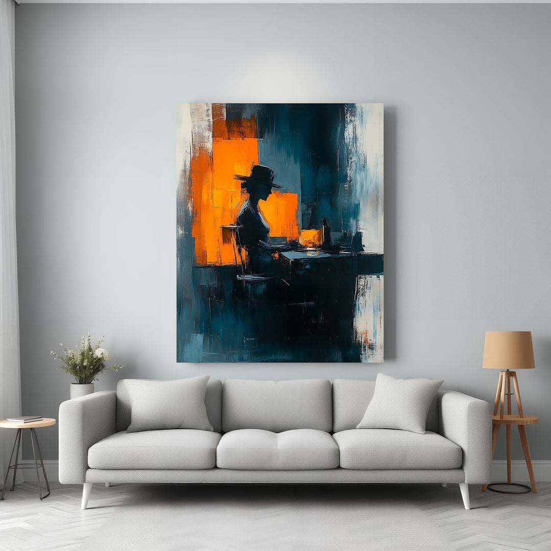 Wadi Home abstract wall art of a silhouetted figure at a desk, with bold strokes of deep blue, orange, and white.