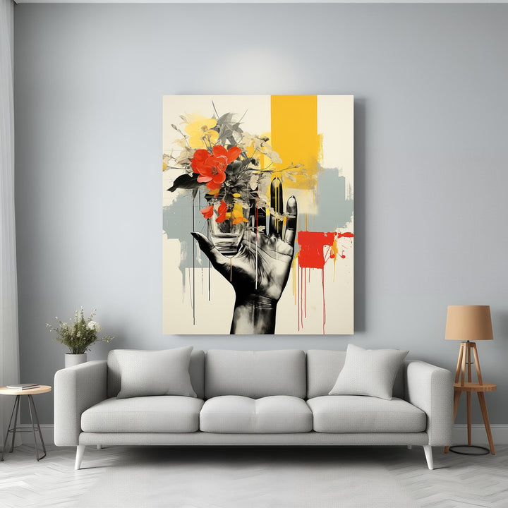 Wadi Home abstract wall art of a hand holding vibrant red and yellow flowers against a backdrop of yellow, grey, and red abstract strokes.