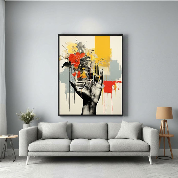 Wadi Home abstract wall art: hand holding vibrant red and yellow flowers against yellow, grey, and red abstract background.
