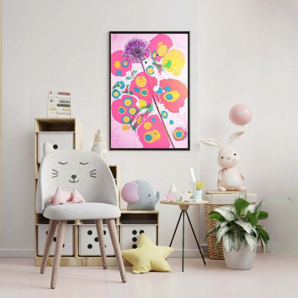 Wadi Home abstract floral wall art with pink, yellow, and blue hues in a black frame, displayed in a child's room.