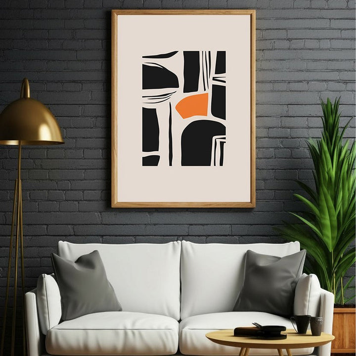 Wadi Home abstract geometric wall art print with black shapes and orange accent on cream background, framed in light wood.