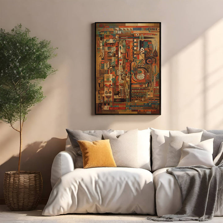 Wadi Home abstract geometric wall art with warm earth tones, deep blues, and reds. Framed artwork above a white sofa.