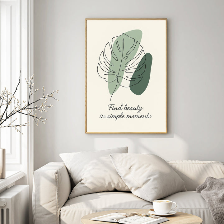 Wadi Home framed wall art with abstract monstera leaf line drawing, sage green shapes, and quote 'Find beauty in simple moments'.