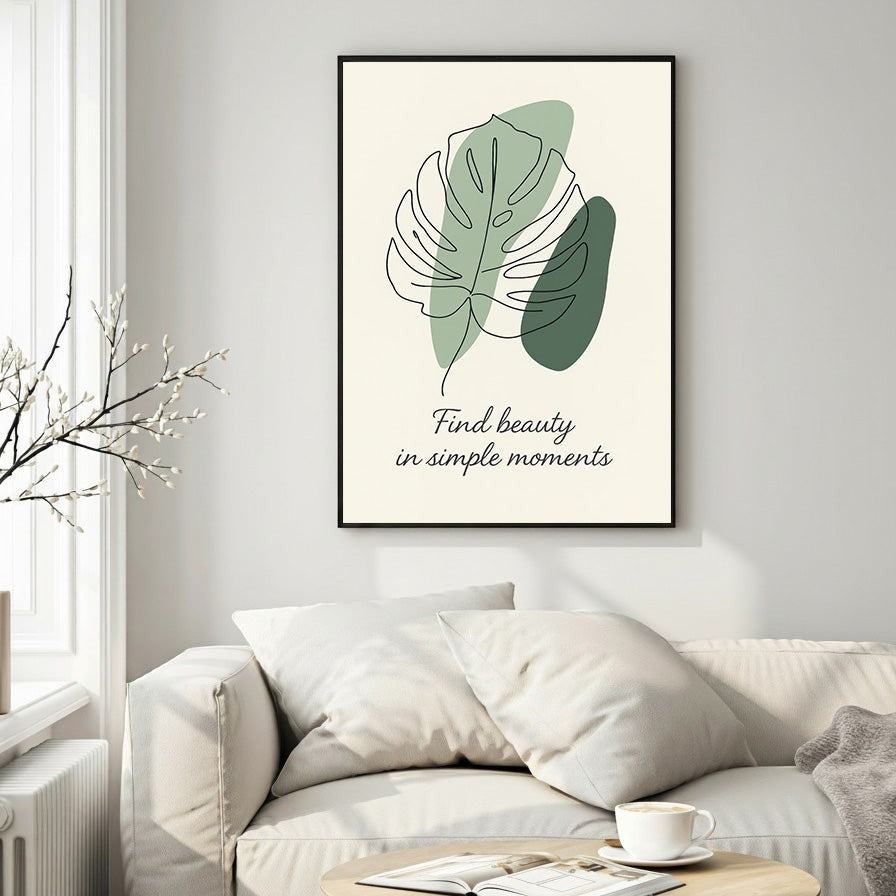 Wadi Home framed wall art with abstract sage green monstera leaf line art and quote "Find beauty in simple moments" on cream background.