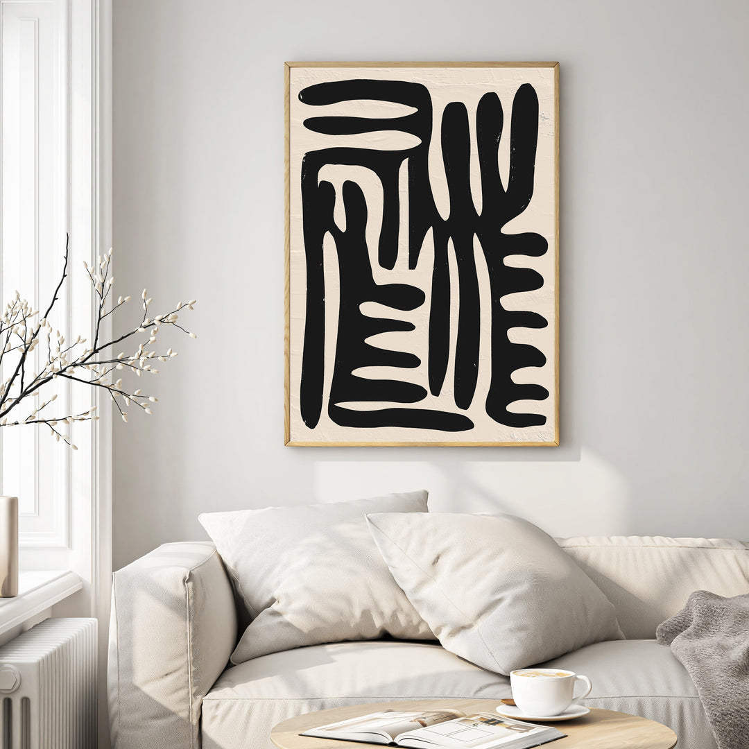 Wadi Home abstract black organic shapes wall art on textured cream background in a modern living room.