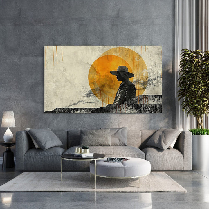 Wadi Home Abstract Silhouette With Sun Wall Art featuring a black silhouette of a person in a hat against a textured orange sun and cream background.