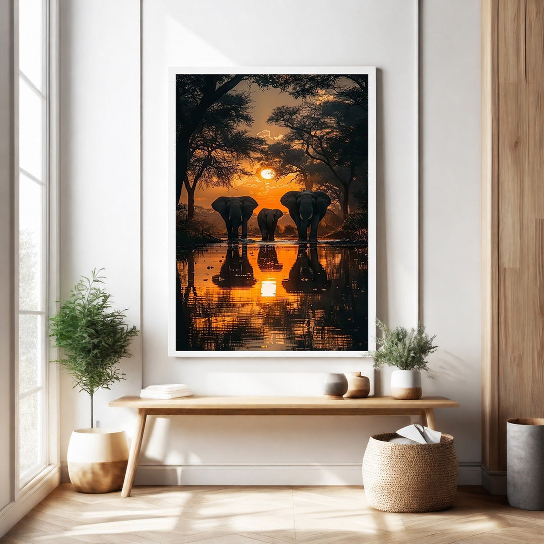 Wadi Home African Sunset Elephant Gathering wall art features a herd of elephants silhouetted against a vibrant orange and purple sunset reflected in water.