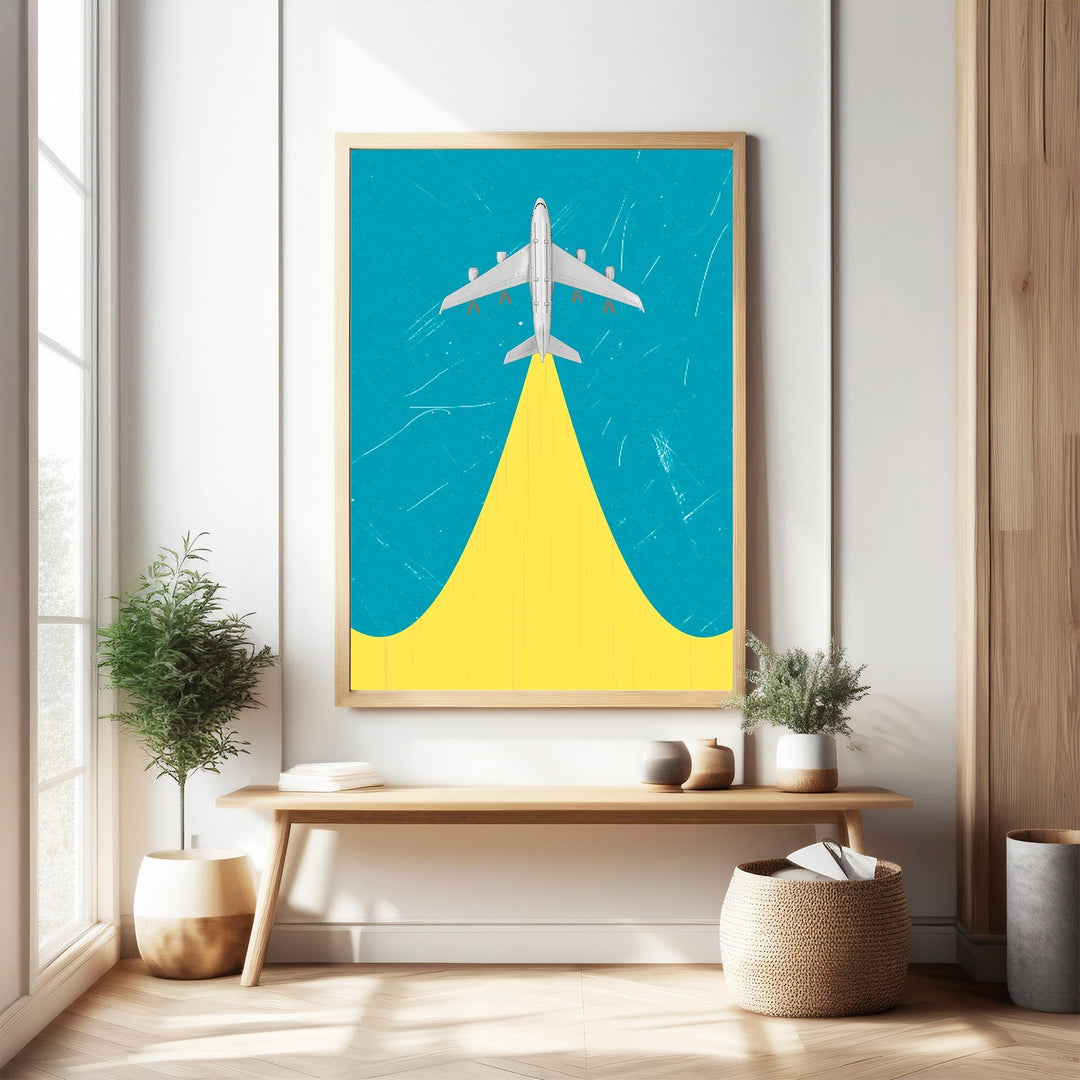 Wadi Home framed airplane ascending artwork with yellow contrail on blue background.